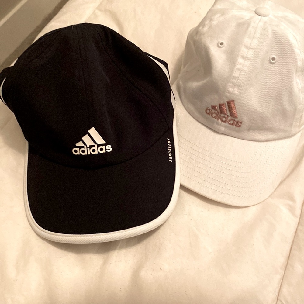 Women’s Adidas hats, one black, one white. One size fits most, it is adjustable